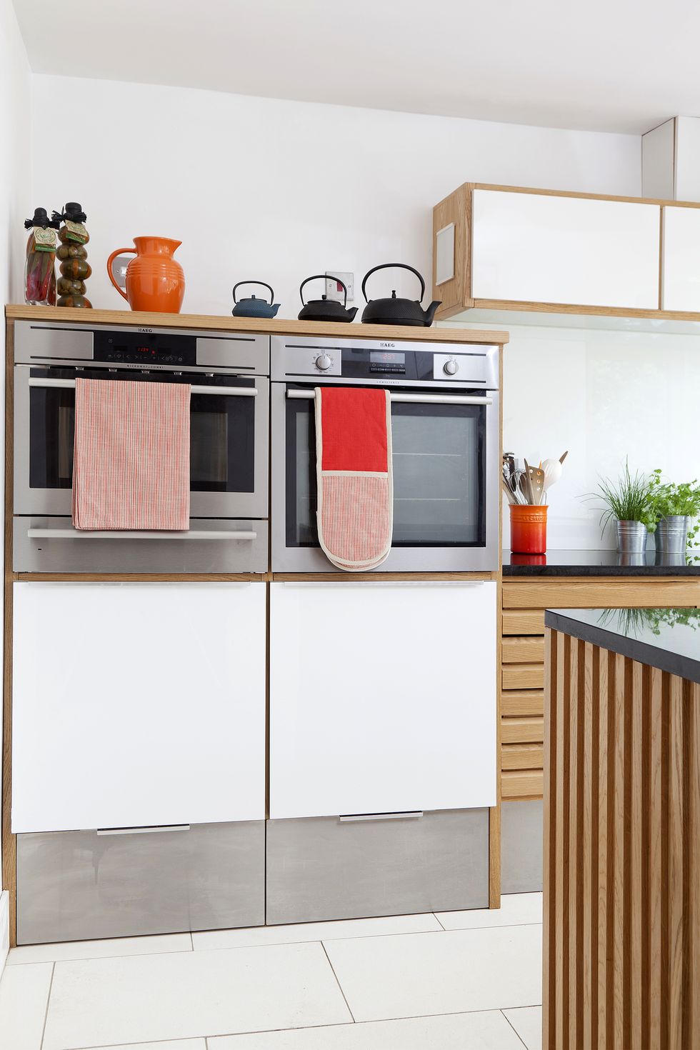 Contemporary kitchen renovation in Waddingham using retro Danish styling and an orange Smeg fridge