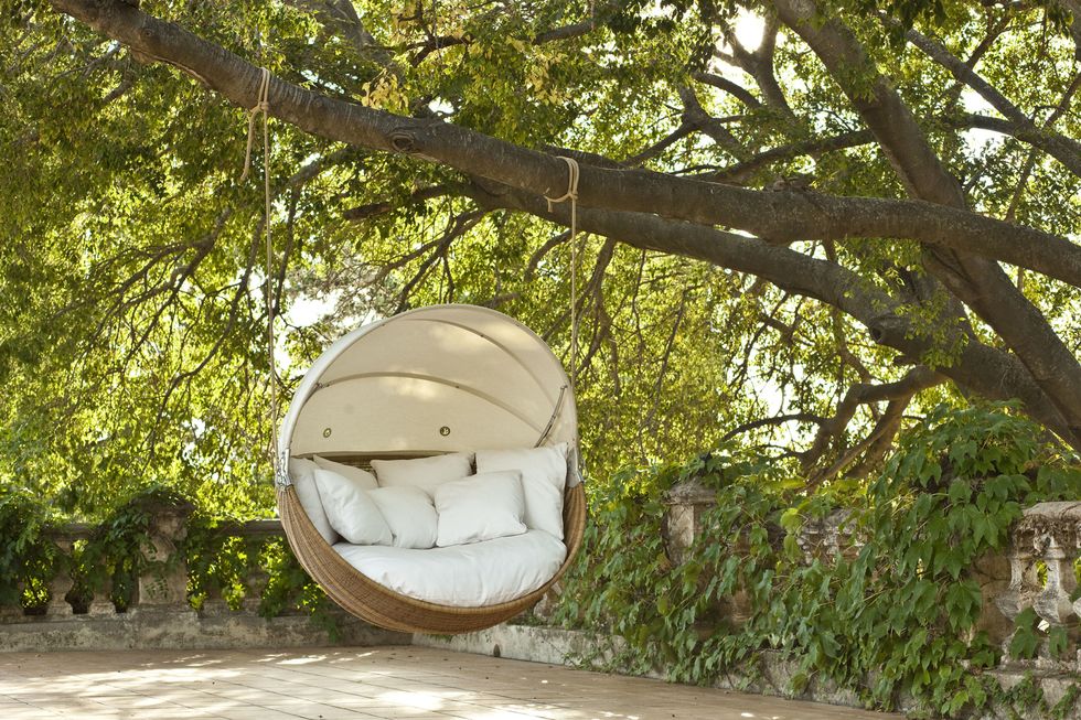 Point Armadillo swinging garden sofa chair is contemporary outdoor furniture.