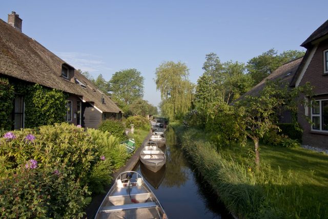 Giethoorn, Netherlands, 04/20/2016: The village still only fully accessible by boat, is one of several places commonly known as the Venice of the North or Venice of the Netherlands. Giethoorn has over 180 bridges and is very popular with tourists.
