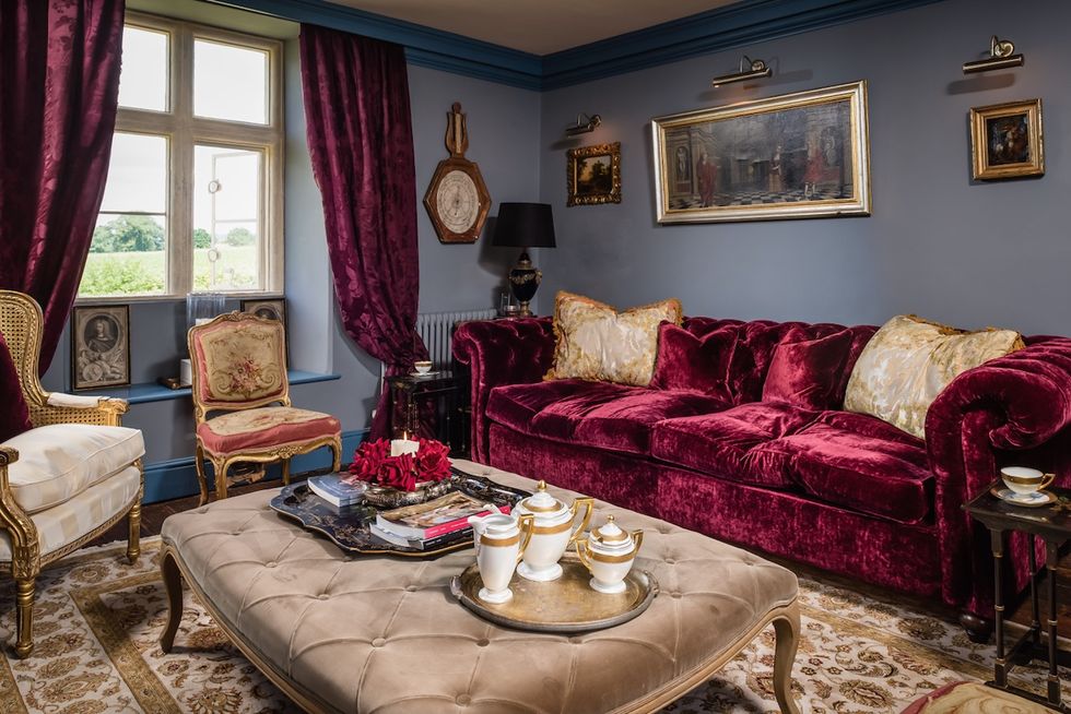 Darcy house - living room - red buttoned velvet sofa