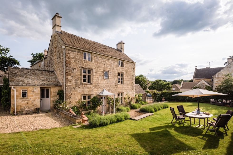 Unique Home Stays: Darcy House stone cottage exterior with dining table and chairs