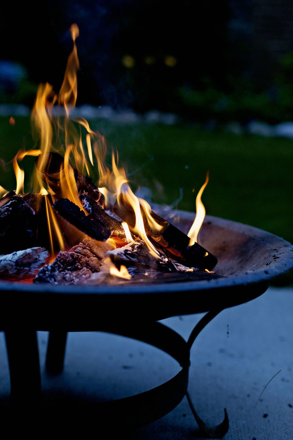 Close-up of burning fire pit at night.