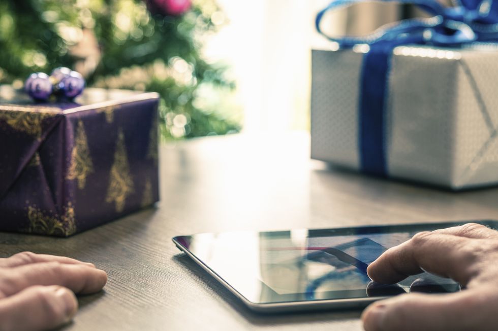 Person using digital tablet at Christmas