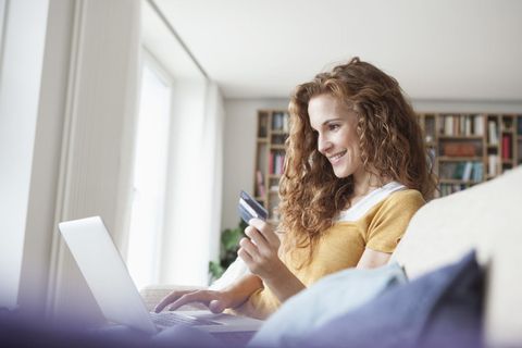 Smiling woman at home shopping online
