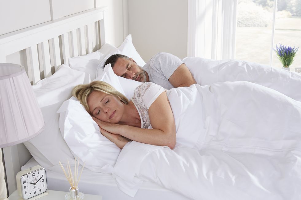Tweak Mattress: half and half mattress. Couple sleeping in bed.