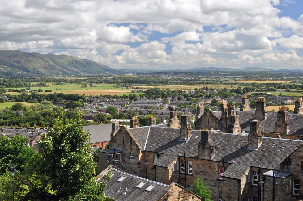 A view over Stirling, Scotland, and the surrounding countryside, in bright sunshine.