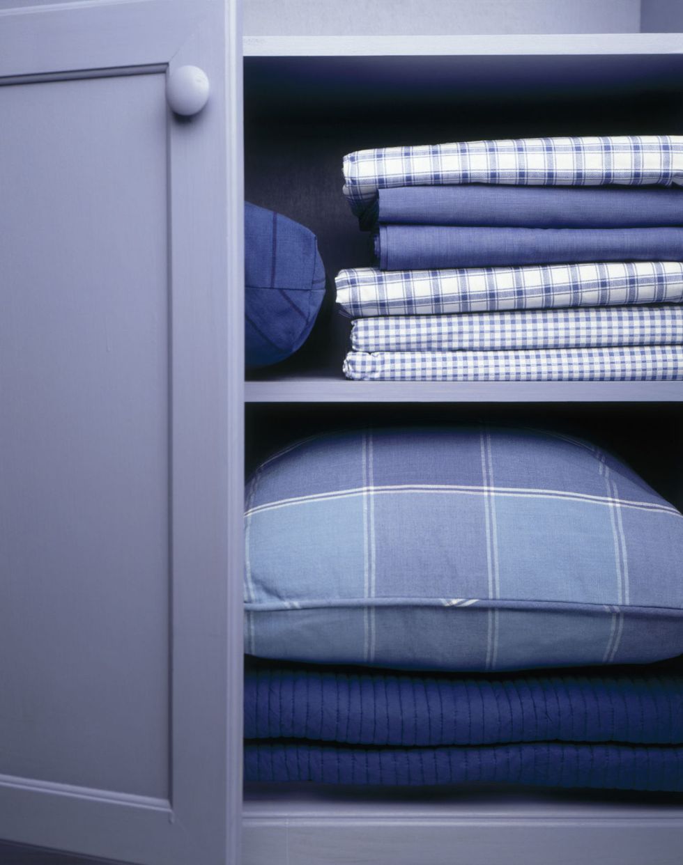 Bed sheets and linen in cupboard