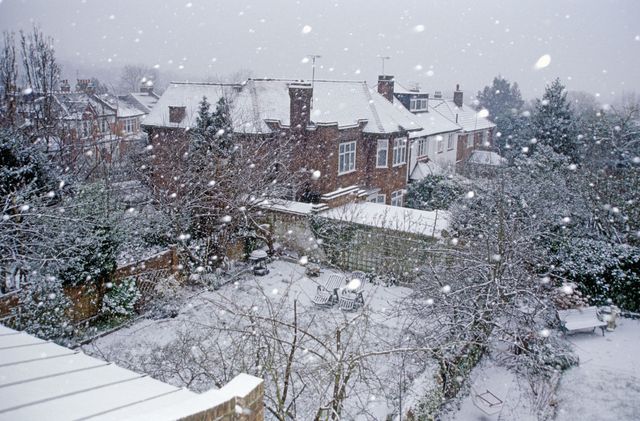 Snow falling on suburban houses of Muswell Hill, London N10, England
