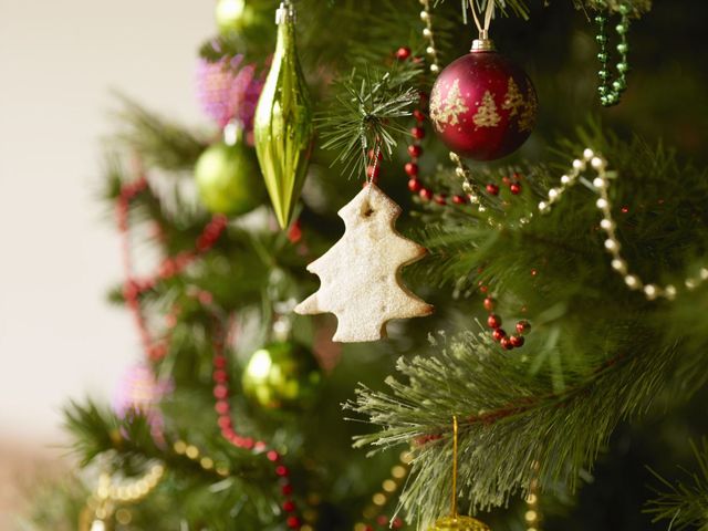 Close up of Christmas tree with baubles and Christmas biscuits