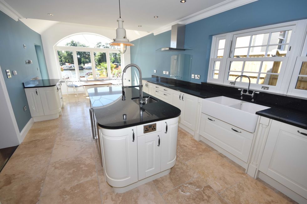Newly fitted kitchen with ivory and black interiors
