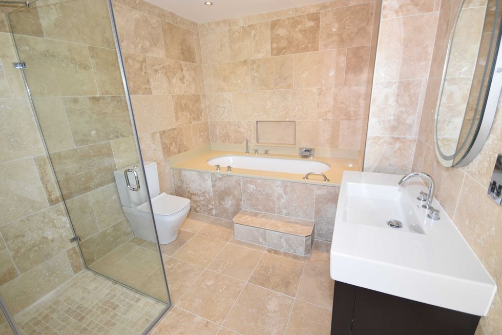 Spacious and light wetroom with sink, toilet and shower