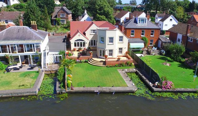Large contemporary house on the River Bure with quay and mooring dock