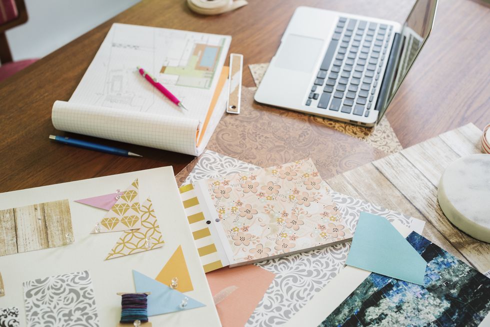 Craft materials, fabric and paper, patterns and a notebook and tablet