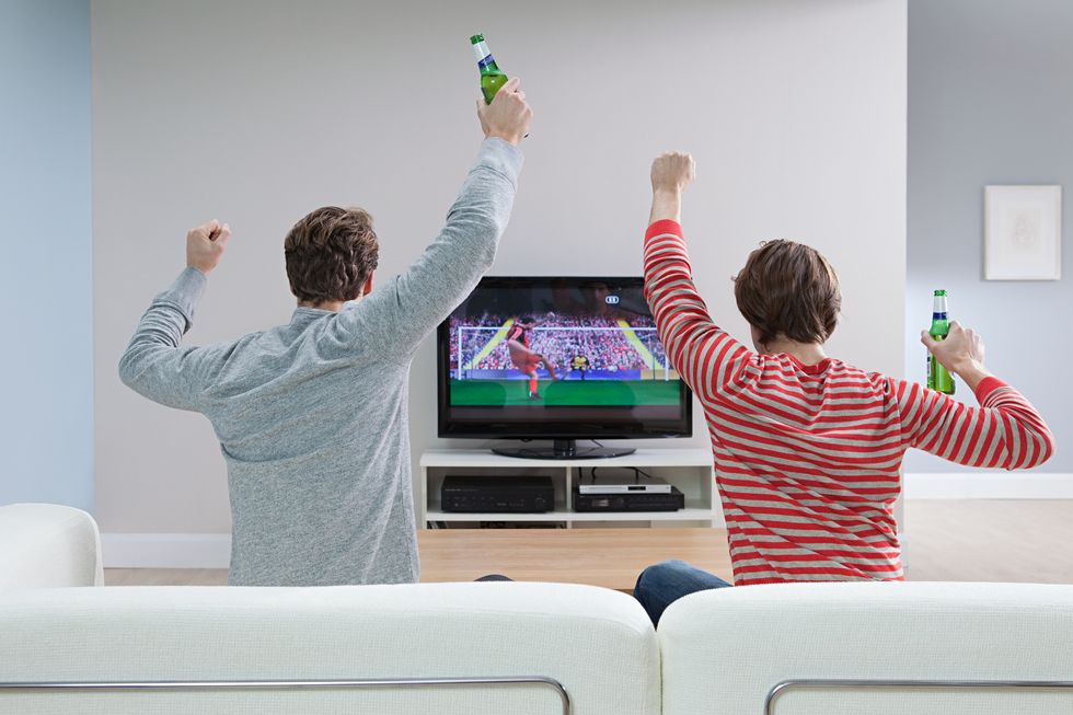 Two men watching football on television