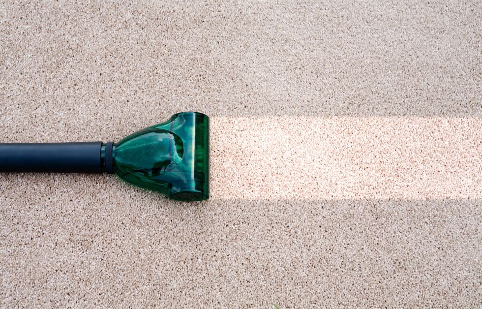 A vacuum cleaning a dirty carpet