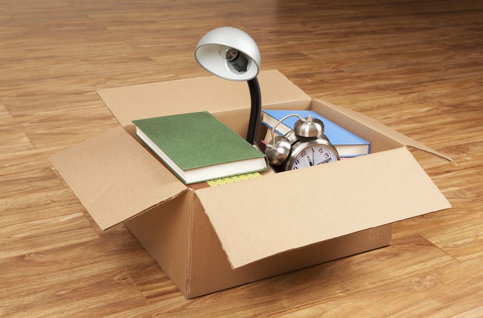 Books, Desk Lamp, and Alarm Clock in Cardboard Box