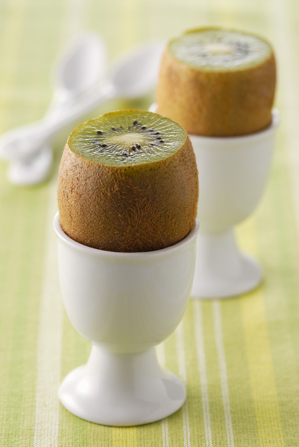 White egg cup holding a kiwi fruit
