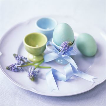 Coloured eggs, eggcups and grape hyacinths