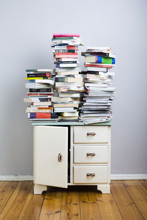 Stacks of books on a cabinet