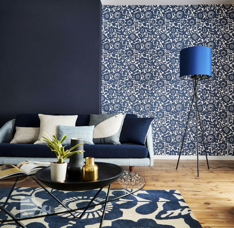 Living room: Kukkia wallpaper, £39 a roll, Scion. Wall painted in Indigo Blue, £43 for 2.5L, Sanderson