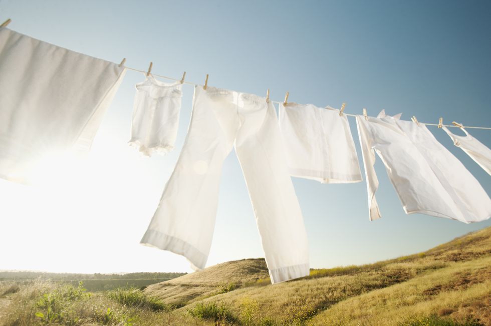 Clean white clothes hanging on outside washing line