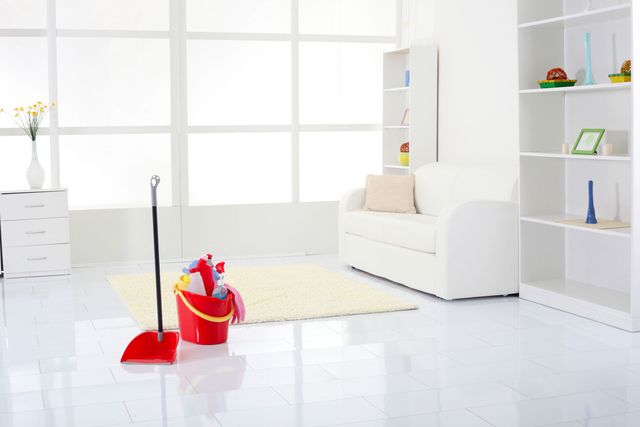 Spotlessly clean white living room - cleaning products in bucket on floor