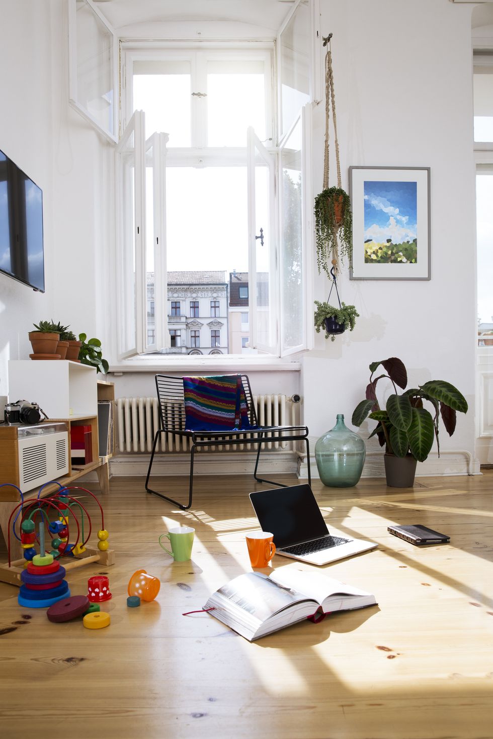 Apartment with toys and laptop on floor