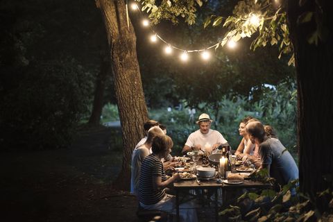 Garden lighting above outdoor dinner table - friends