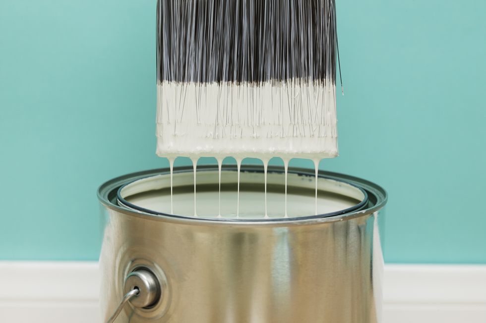 Paint brush with paint and paint can