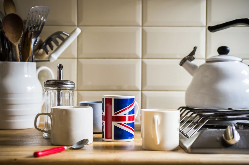 Kitchen counter with jug of utensils and coffee mugs