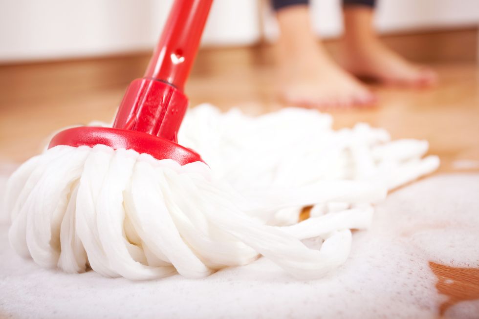 Woman mopping a wooden floor