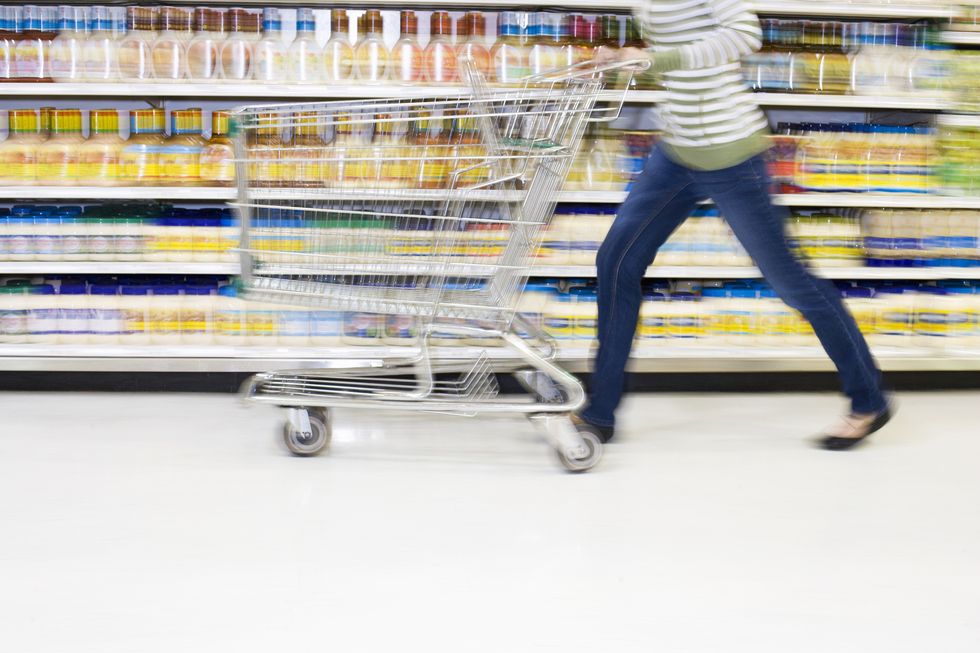 Shopper with in a hurry with cart in aisle