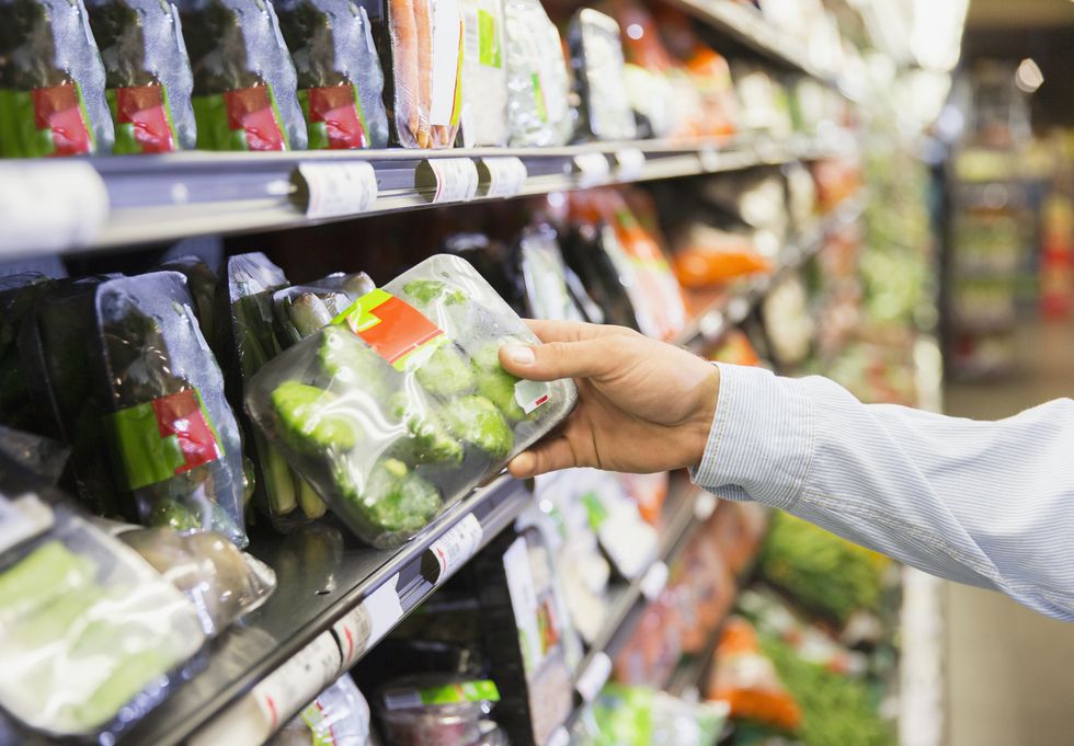 Close up of man holding produce in grocery store