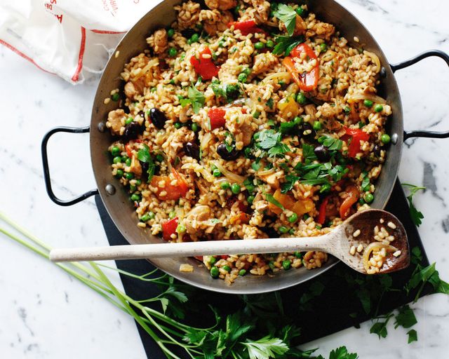 Wok with chicken paella with vegetables and parsley