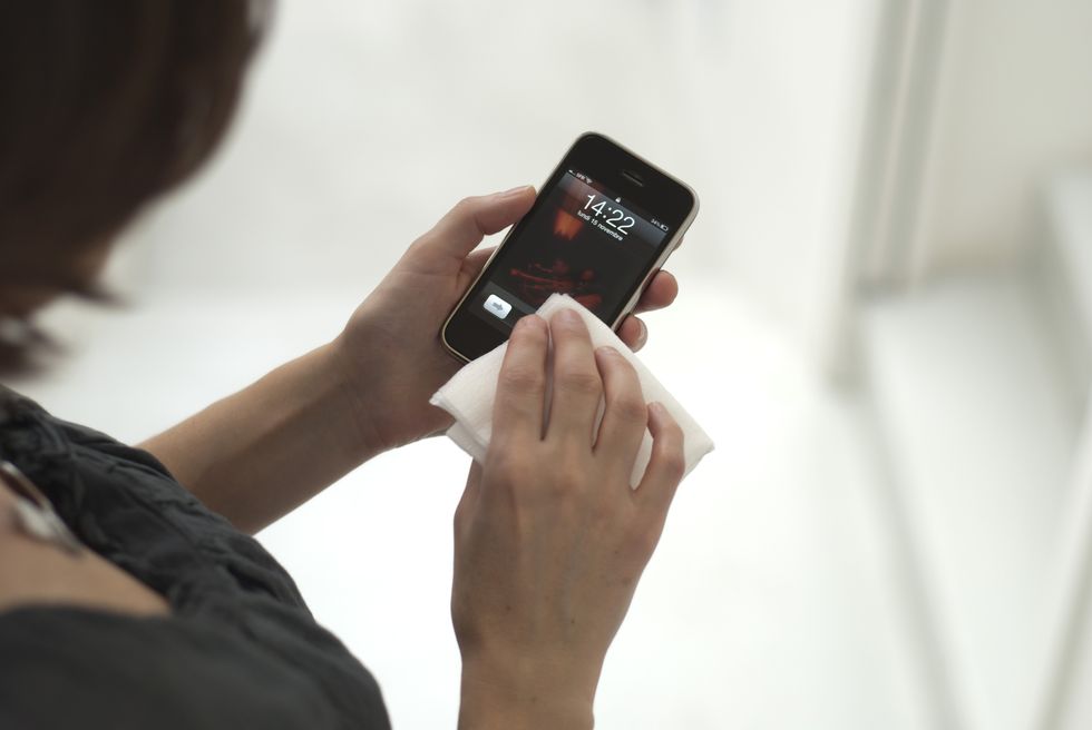 Woman cleaning iPhone