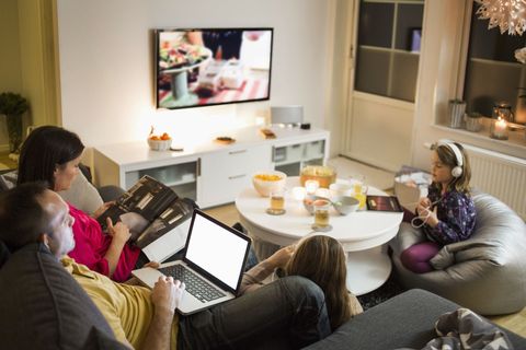 Family using technologies in living room