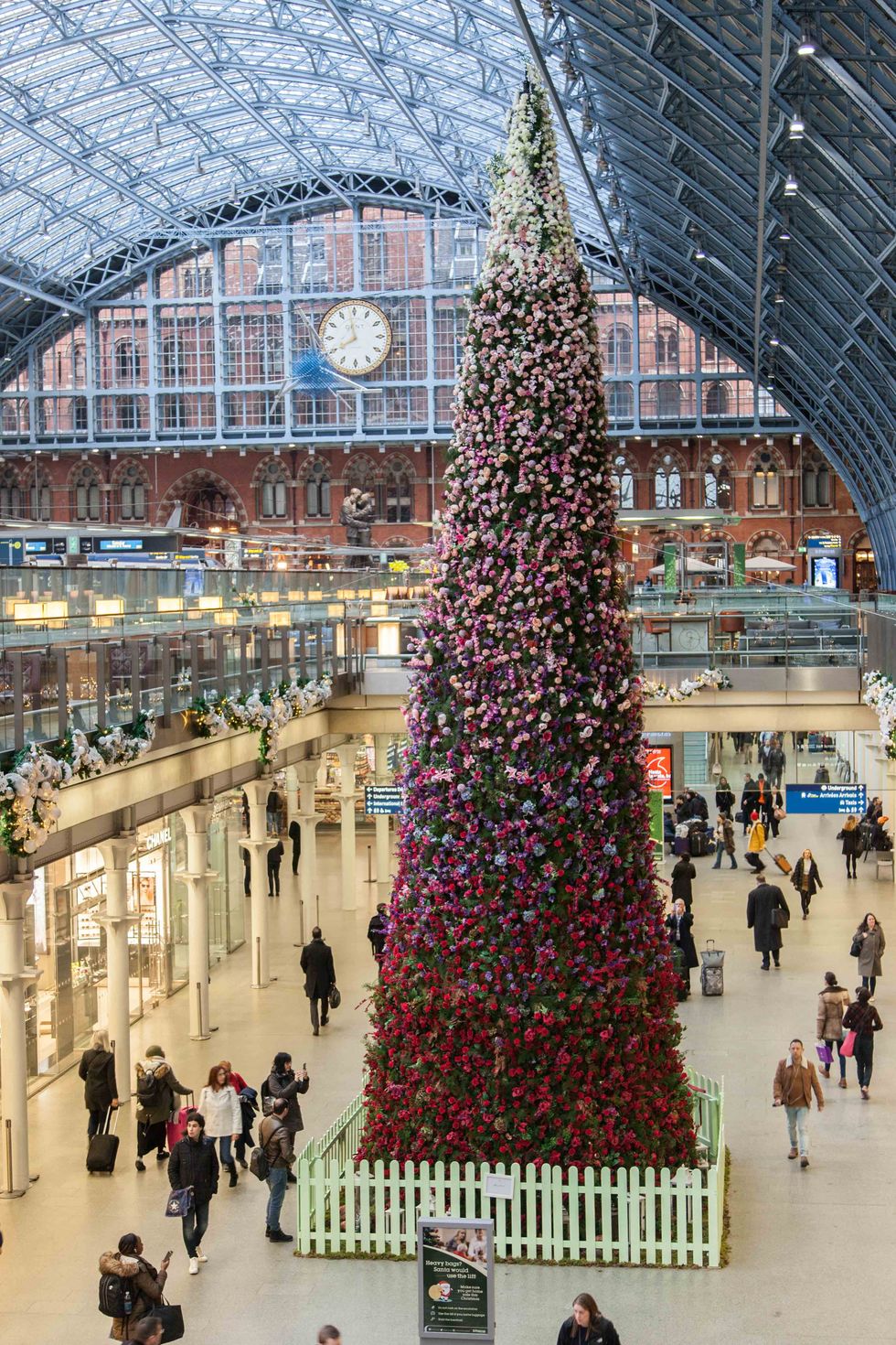 47ft floral Christmas tree unveiled at St Pancras International station, London.