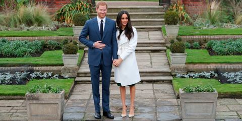 Britain's Prince Harry and his fiancée US actress Meghan Markle pose for a photograph in the Sunken Garden at Kensington Palace in west London on November 27, 2017, following the announcement of their engagement
