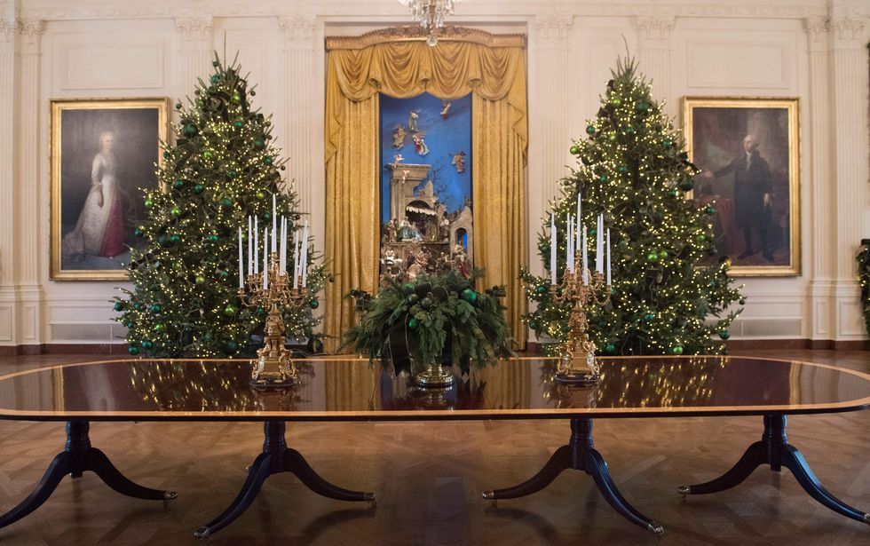 <p>Two of the 53 Christmas trees flank a nativity scene in the East Room. The theme 'Time-Honoured Traditions'&nbsp;reflect 200 years of holiday celebrations at 1600 Pennsylvania Avenue. </p>