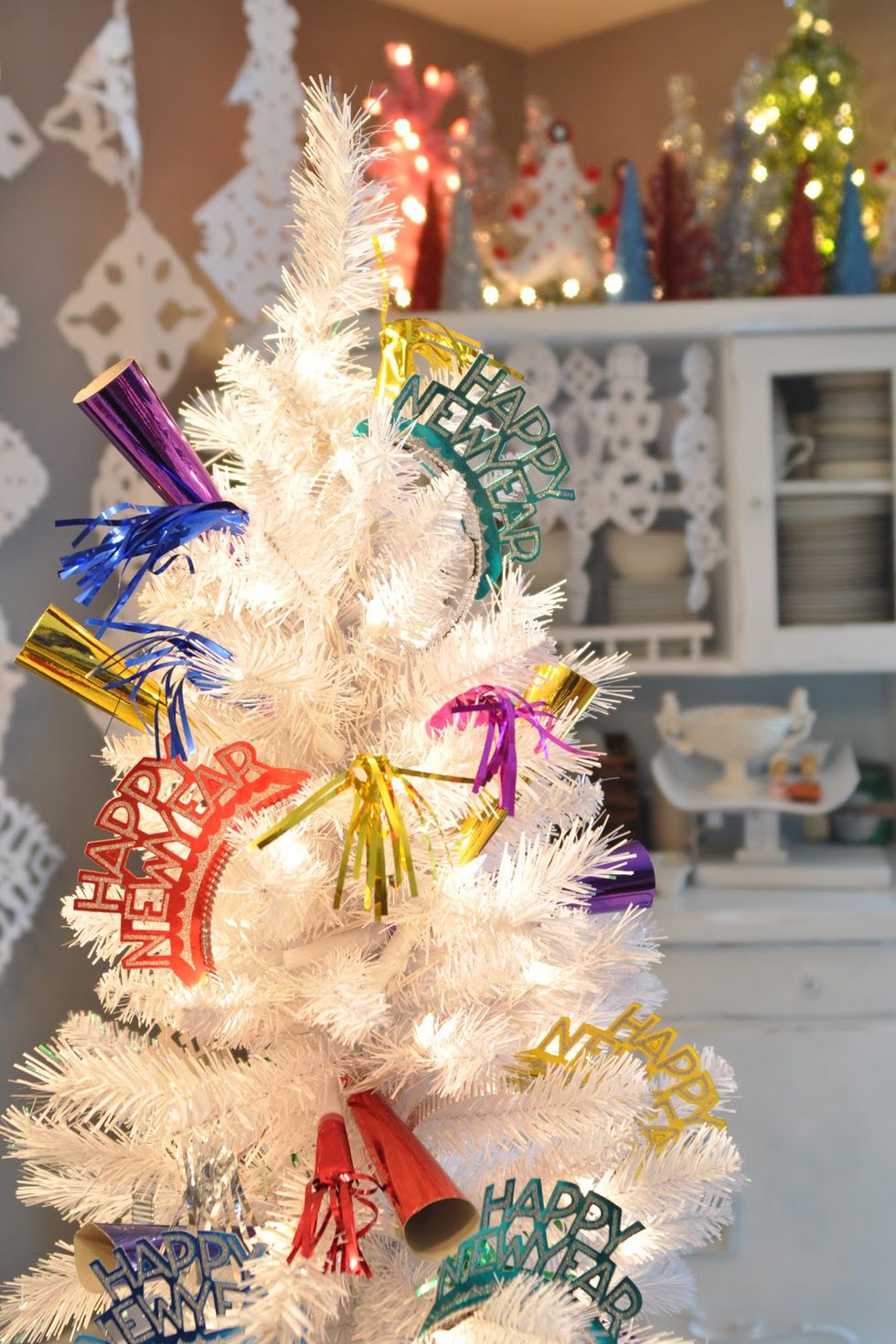 <p>Strip your tree down to the needles and lights, and then adorn it with party poppers and streamers.&nbsp;It doesn't get easier than that!</p><p><em data-redactor-tag="em"><a href="http://www.domesticfashionista.com/2011/12/new-years-eve-tree.html" target="_blank" data-tracking-id="recirc-text-link" data-href="http://www.domesticfashionista.com/2011/12/new-years-eve-tree.html">Get the tutorial from Domestic Fashionista »</a></em></p>