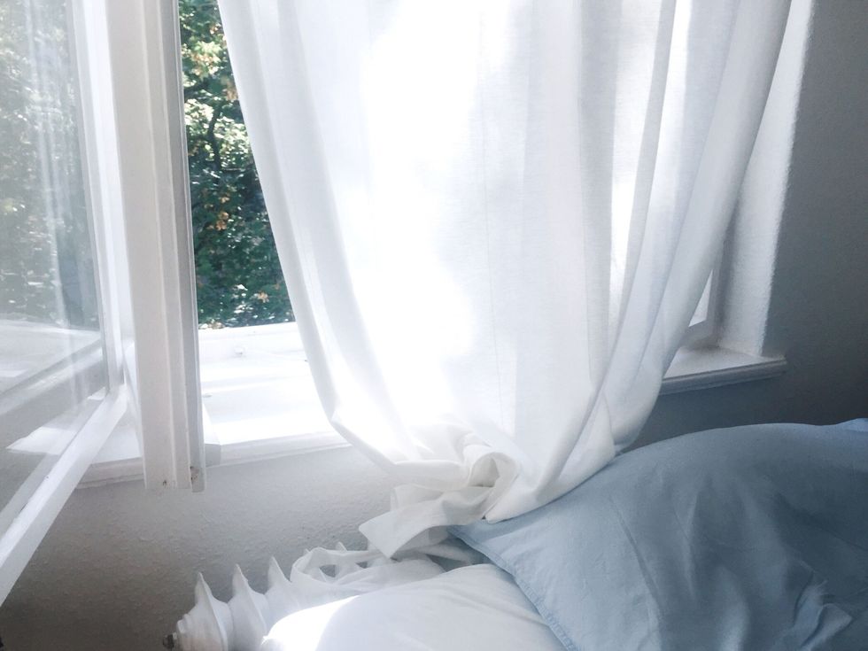 White Curtain Hanging At Window In Room