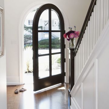 An Arched Doorway Opens To Hallway