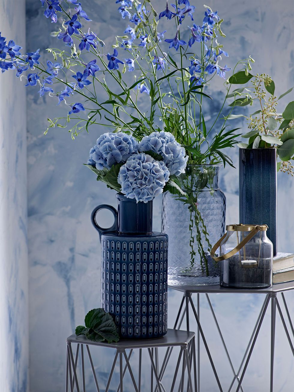 Indigo blue flowers, vase and backdrop