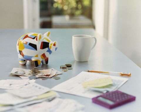 The Best Apps To Help You Manage Your Money - piggybank british currency calculator receipts and a mug on a table