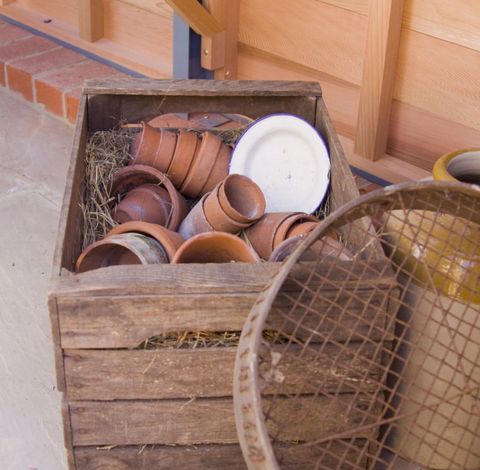 Terracotta pots in wooden crate