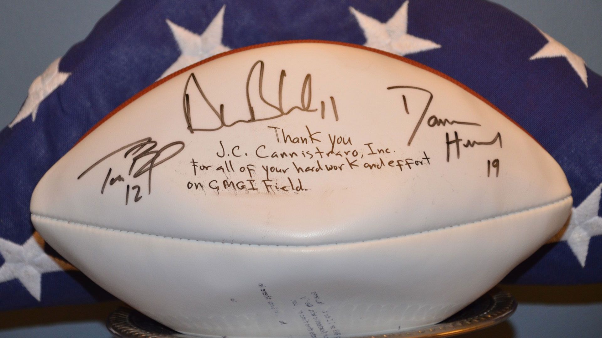 Mass. business reunited with football signed by Brady, Bledsoe