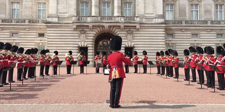 Marching, Bearskin, Uniform, Marching band, Headgear, Palace, College, Troop, Team, Tourism, 