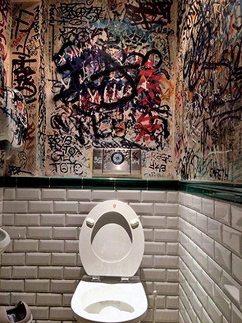 Toilet, Wall, Room, Toilet seat, Art, Plumbing fixture, Graffiti, Street art, Brickwork, Architecture, 