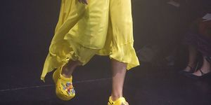 Yellow, Footwear, Human leg, Shoe, Leg, Fashion, Joint, Performance, Human body, Performance art, 