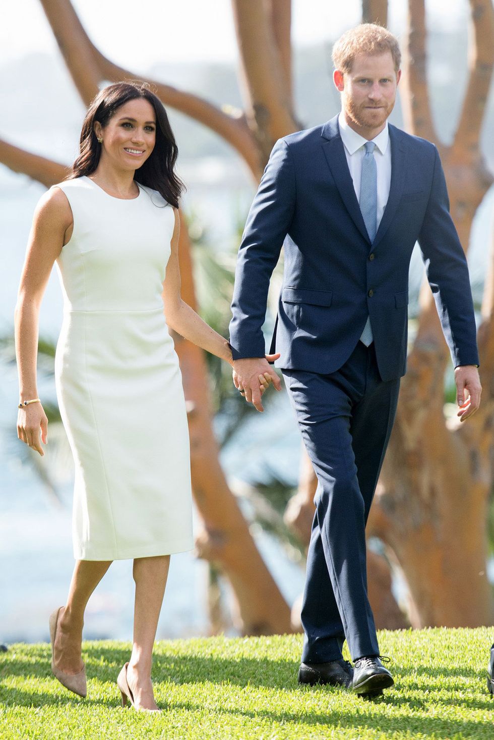 Clothing, Suit, Formal wear, Yellow, Holding hands, Dress, Gesture, Fashion, Walking, Interaction, 